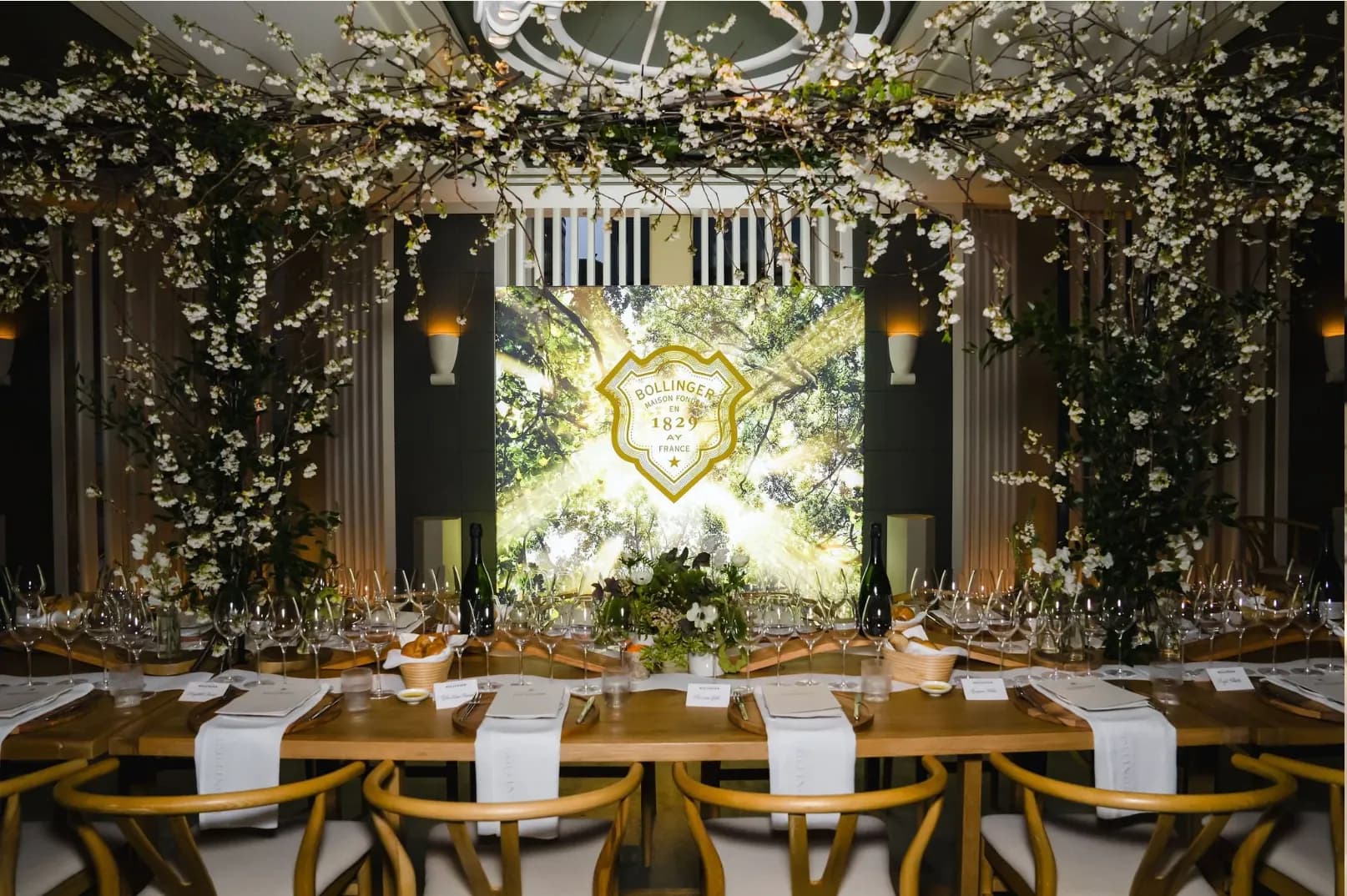 Le Jardinier private dining room set for a seated dinner beneath a canopy of white blossoms