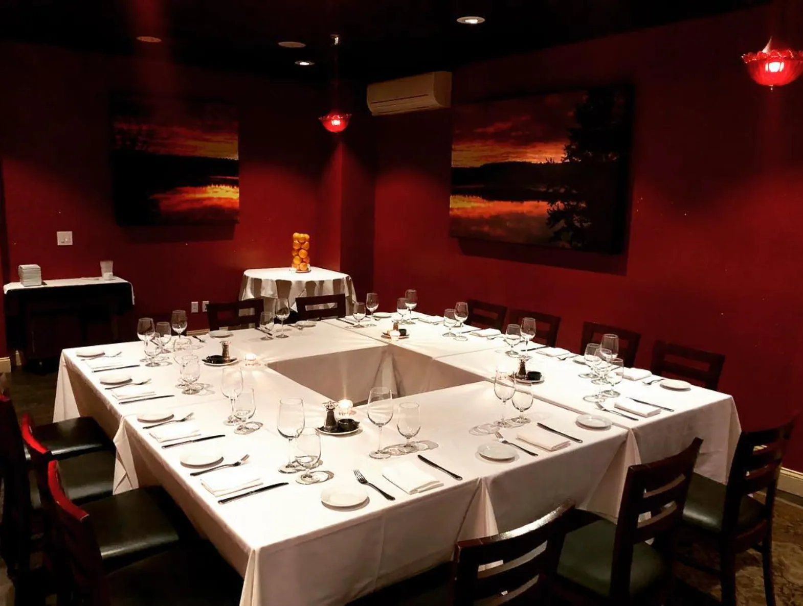 Private room at Mike's Bistro set for a square-table dinner