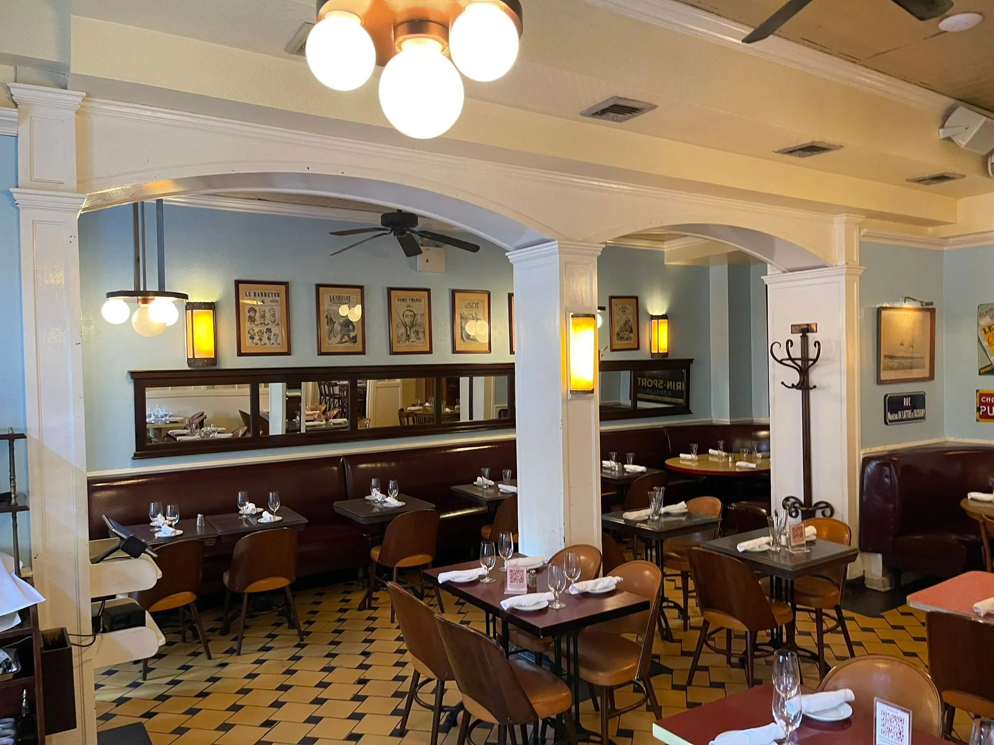Le Monde brasserie interior with banquettes and globe lights